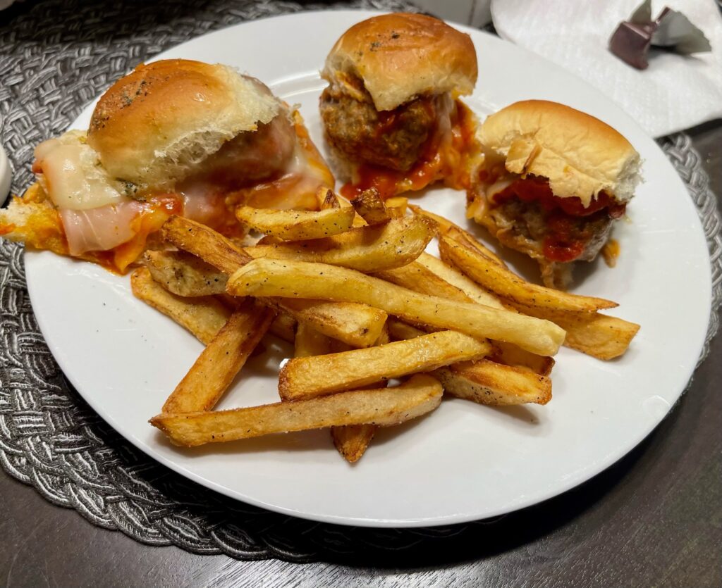 Smoked meatball sliders on a plate with homemade fries