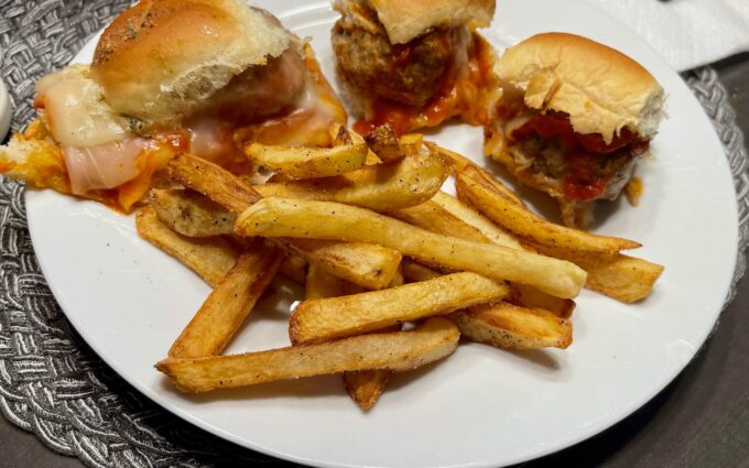 Smoked meatball sliders on a plate with homemade fries